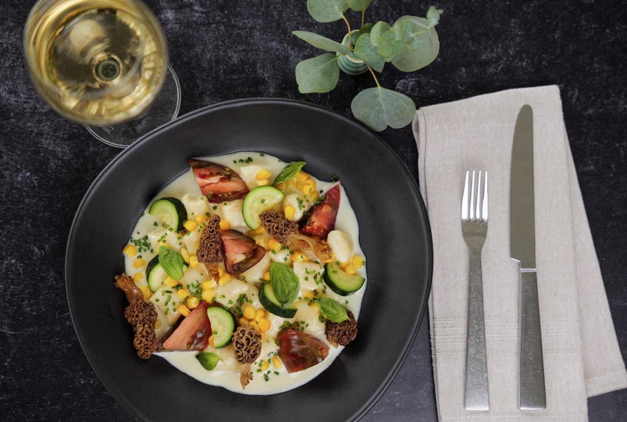 a bowl of pasta with fresh garden vegetables