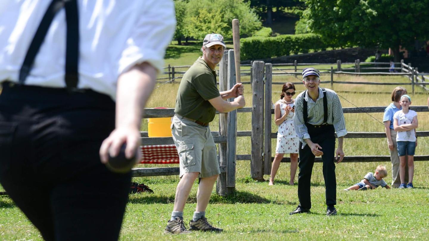 Staff and visitors enjoying an old fashioned game of base ball