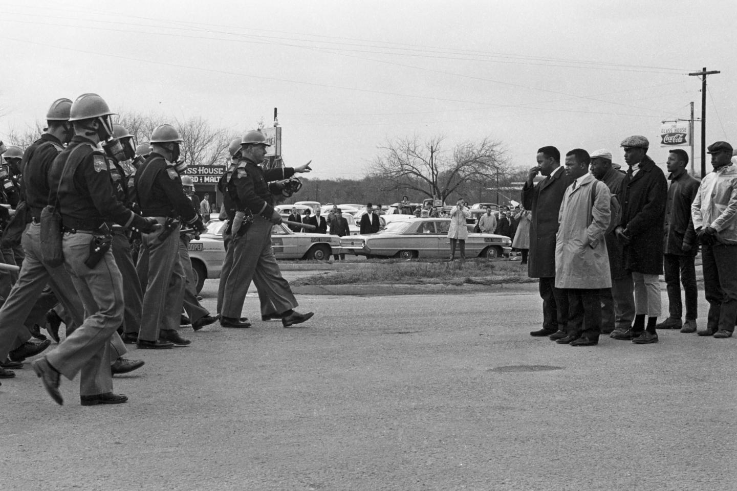 John Lewis and several civil rights protesters stand before armed police