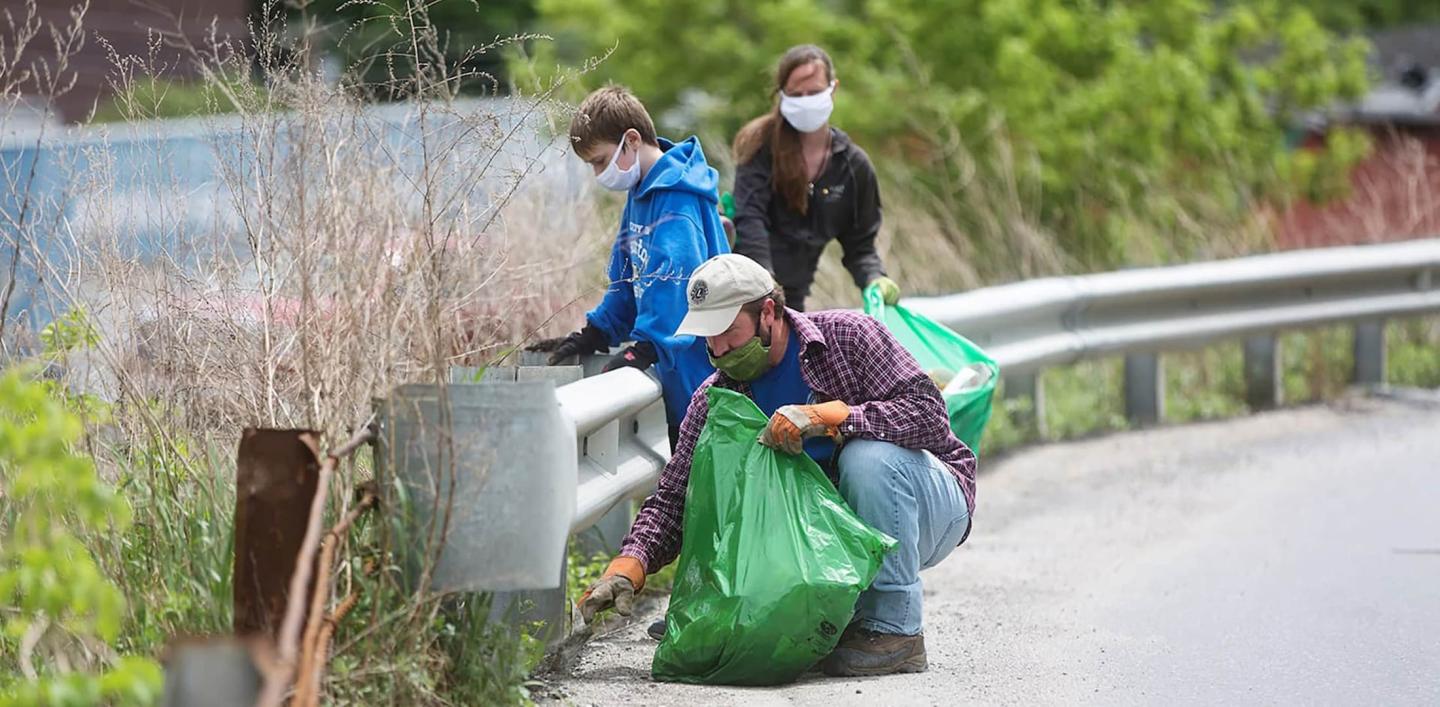 volunteers cleaning up on the side of the road