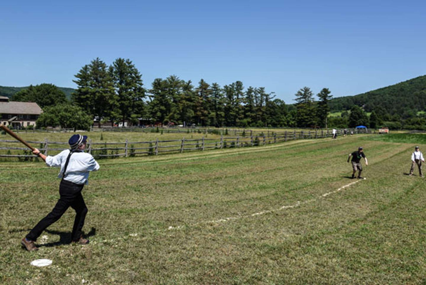 Guests playing old style baseball.