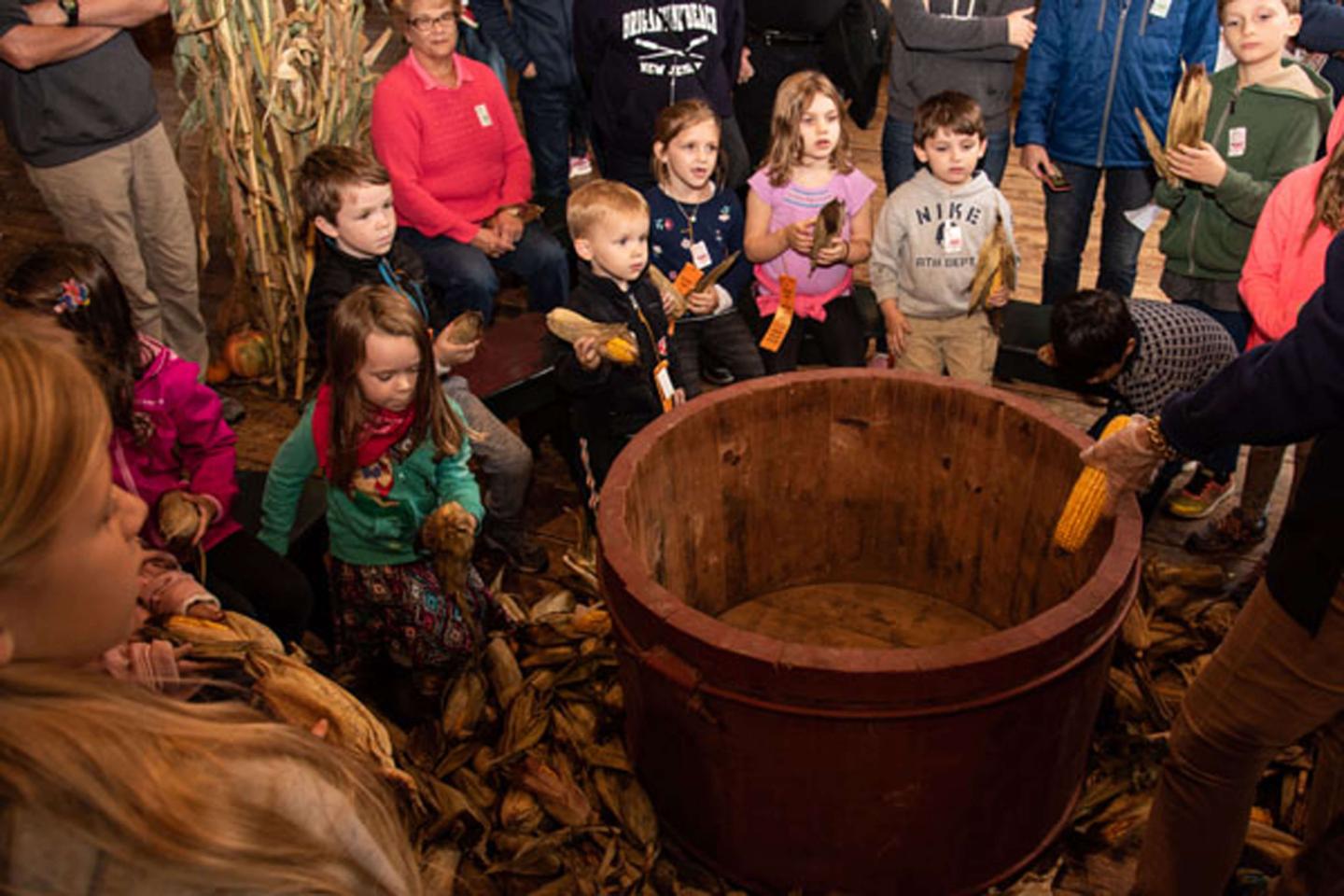 Guests participate in husking challenge.