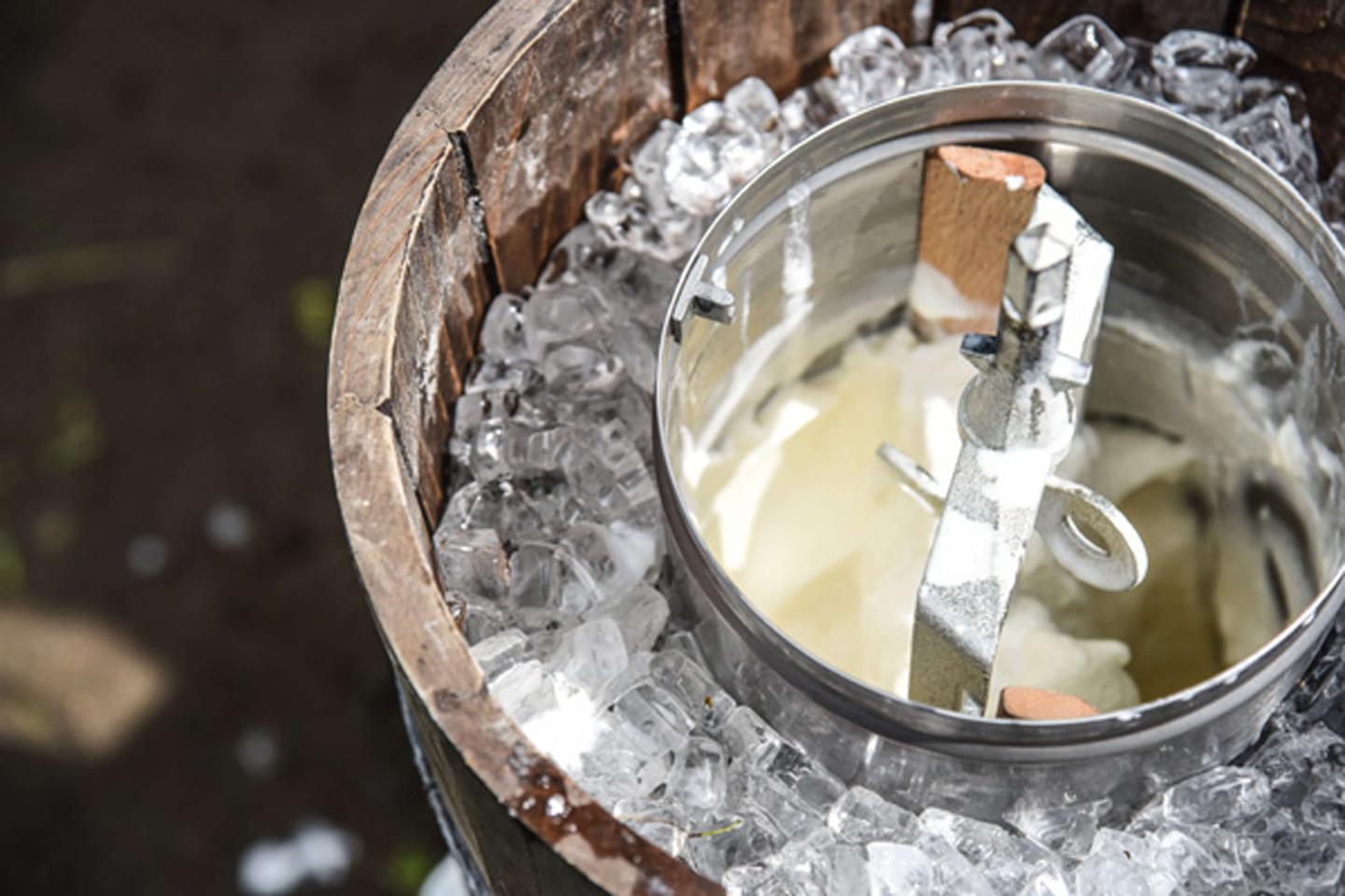 Ice cream being made in an antique churn.