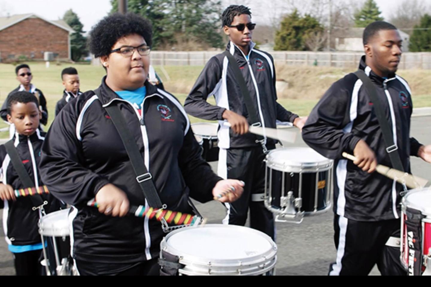 Members of the River City Drum Corps play their drums