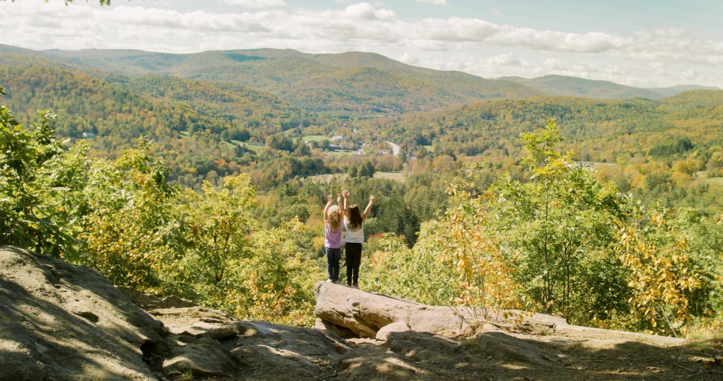 Two girls overlooking vermont mountains