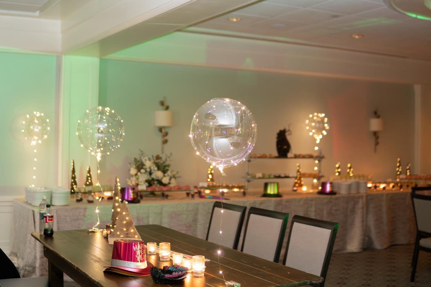 Clear balloons with twinkle lights and new year's eve party decorations