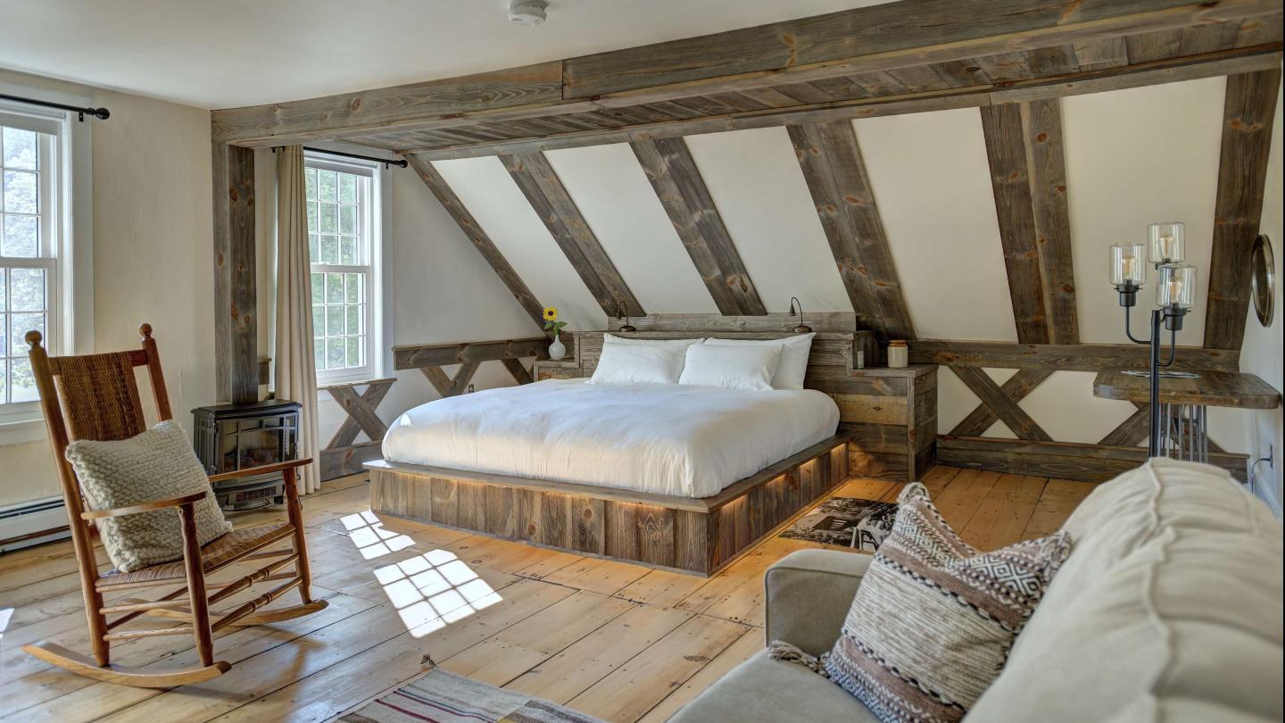 inside of a room with platform bed, woodwork, and a rocking chair