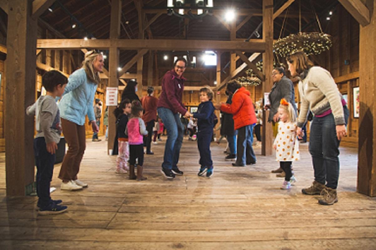 Families barn dancing in the fall.