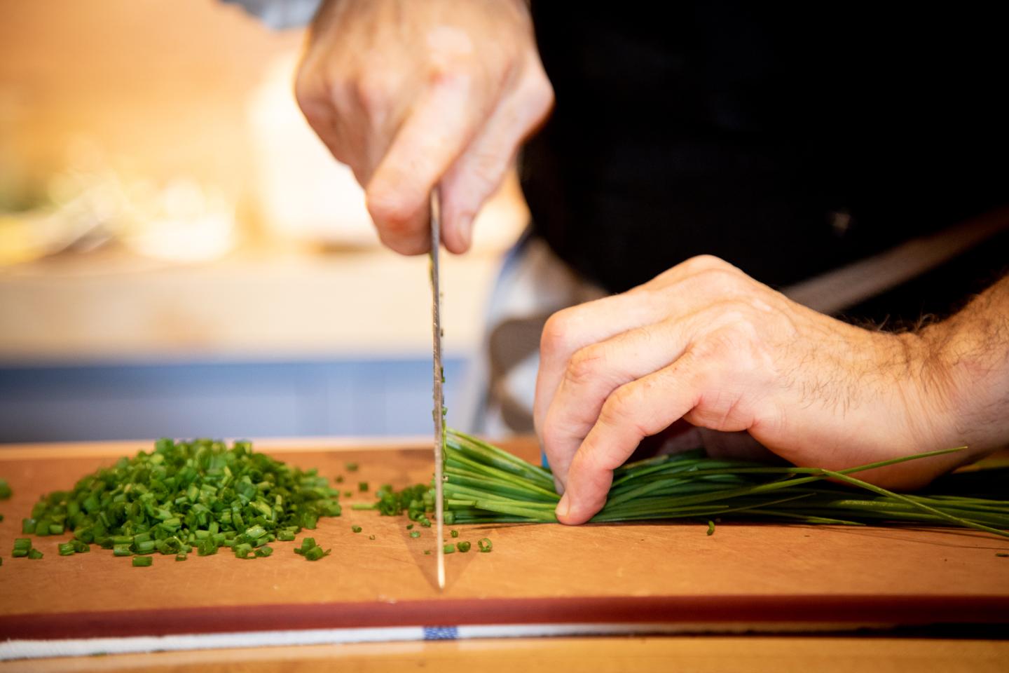 Chef chopping chives