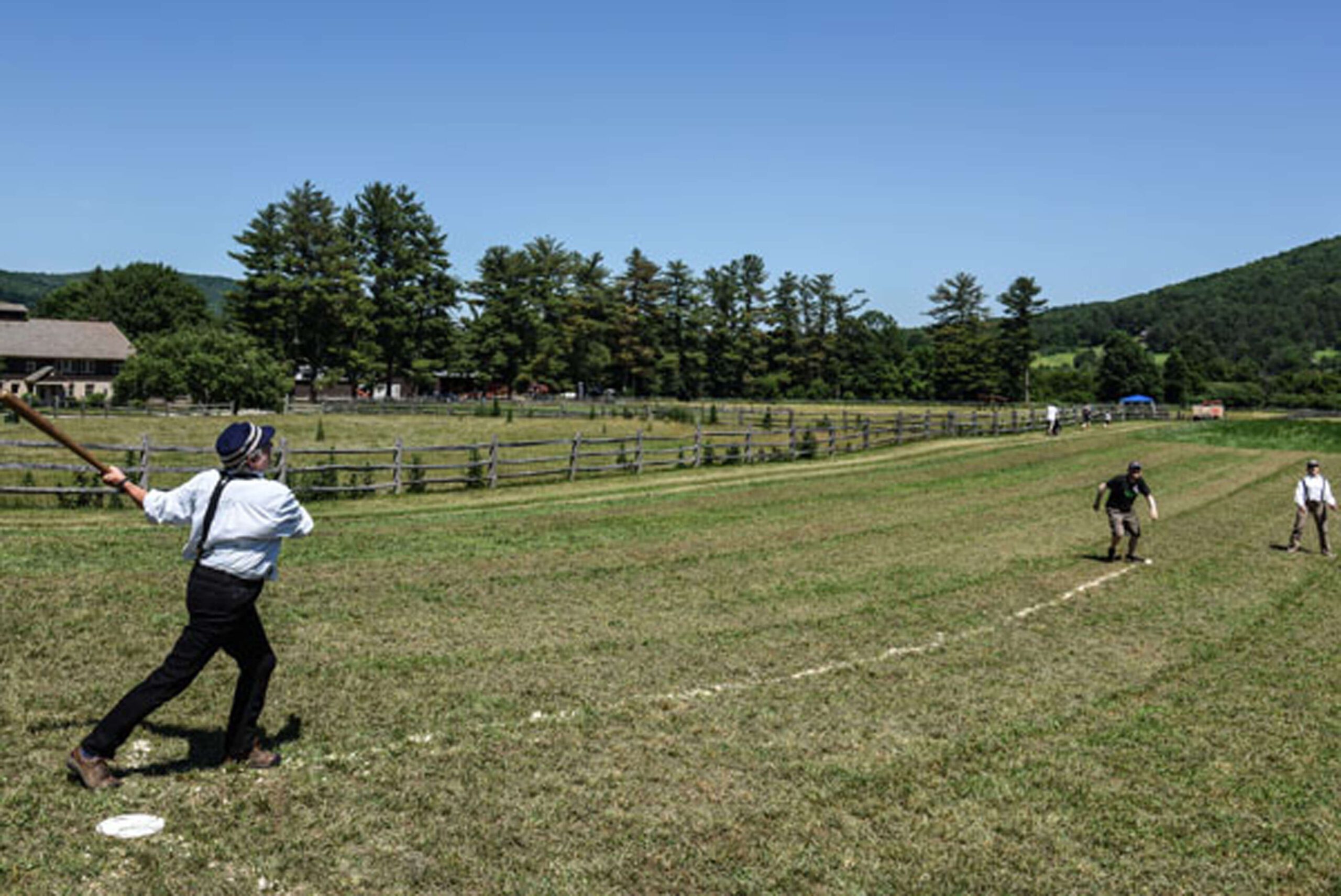 Guests playing old style baseball.