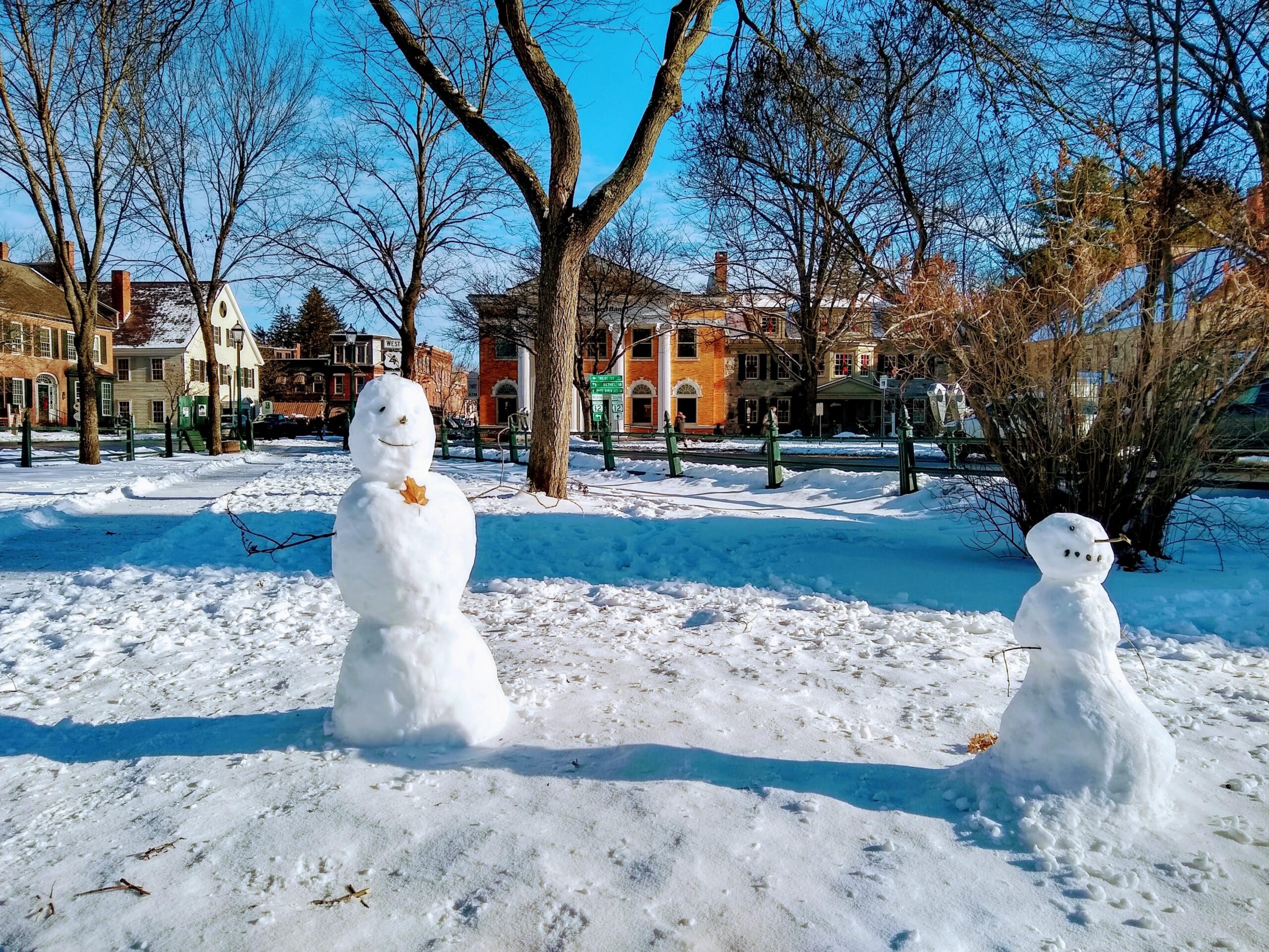 Snowmen on the green facing town