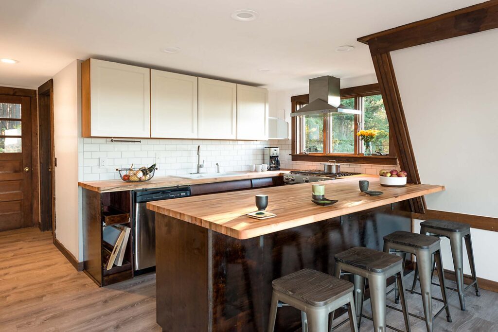 Kitchen stocked with essentials and counter seating for four