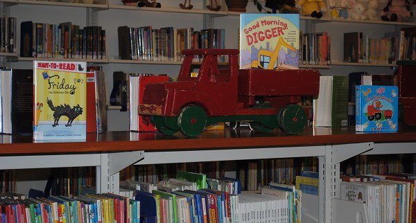 book shelf with toy truck at NWPL