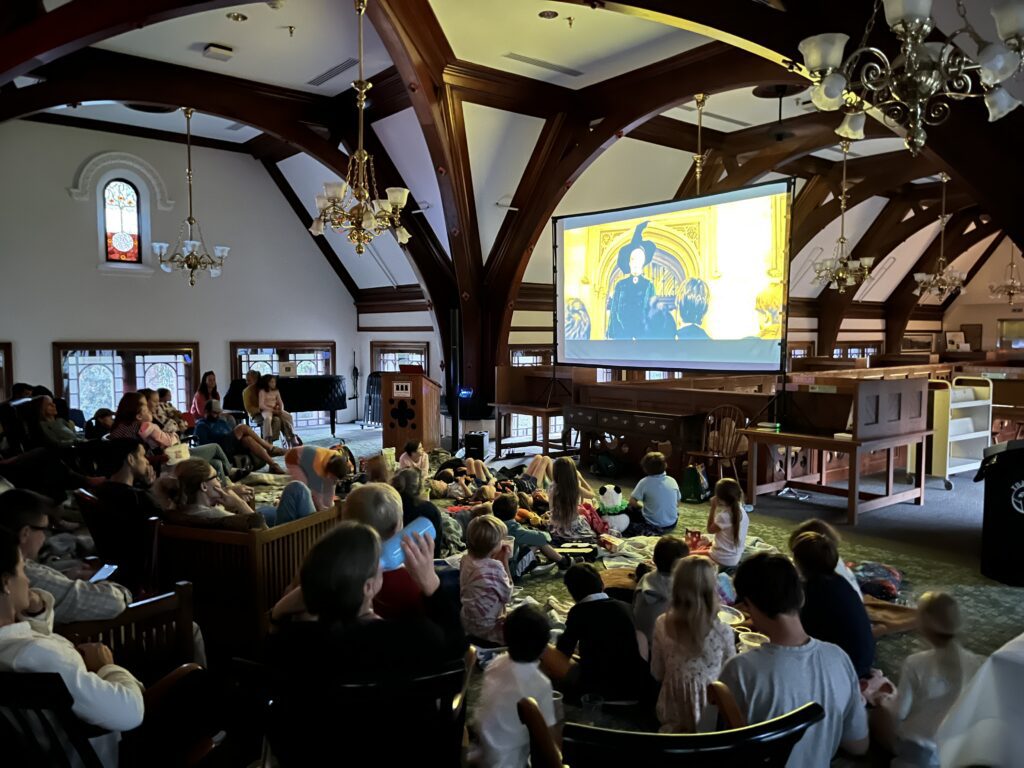 Families watching a movie at the library